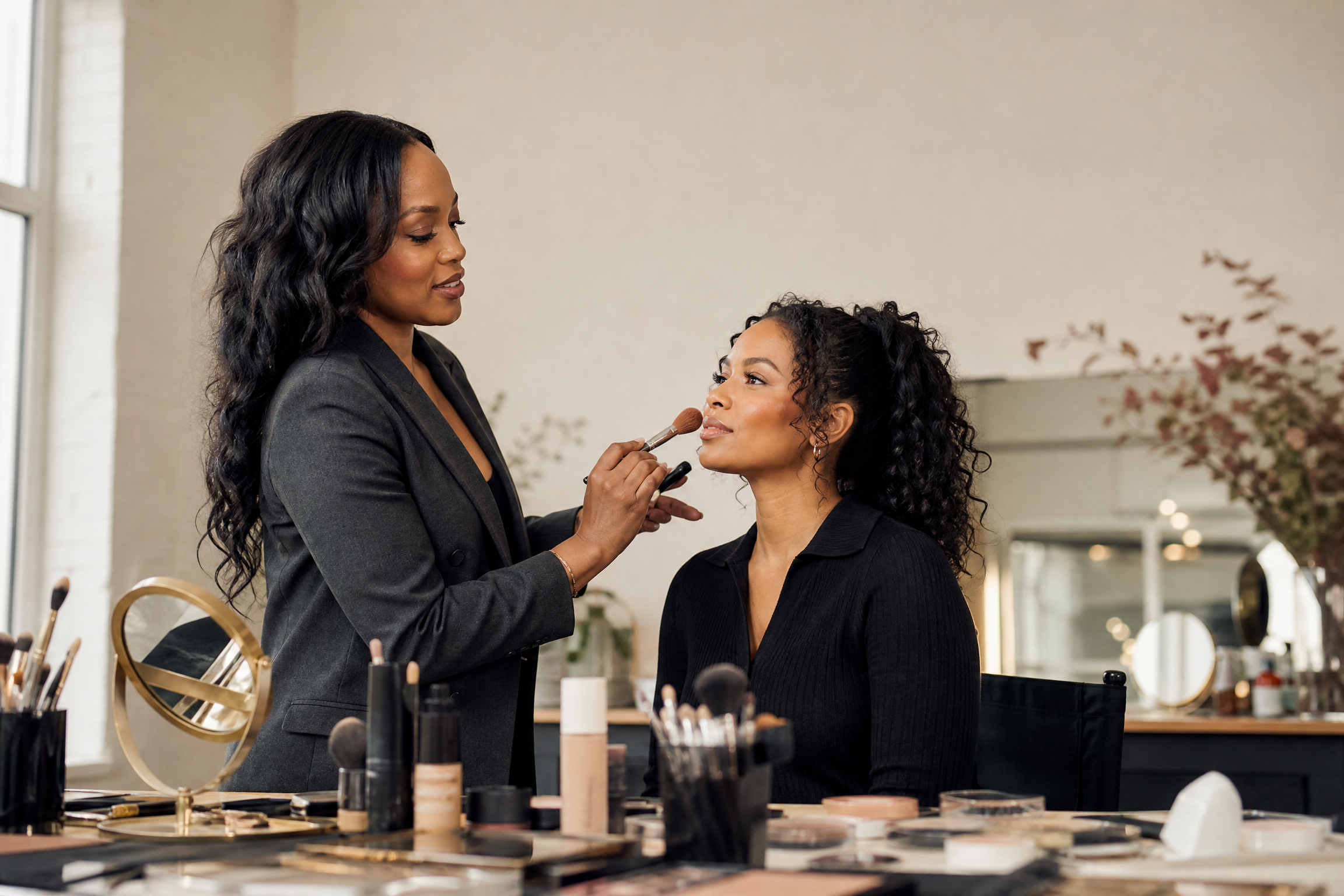 Beauty educator teaching complexion technique to students in the studio