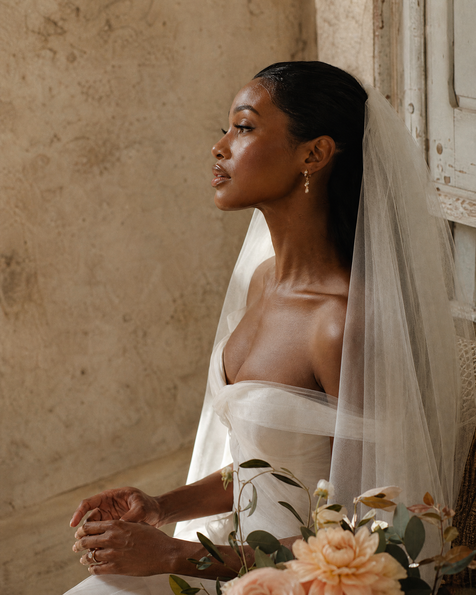 Bride with soft luminous bridal makeup and a veil, photographed in natural light